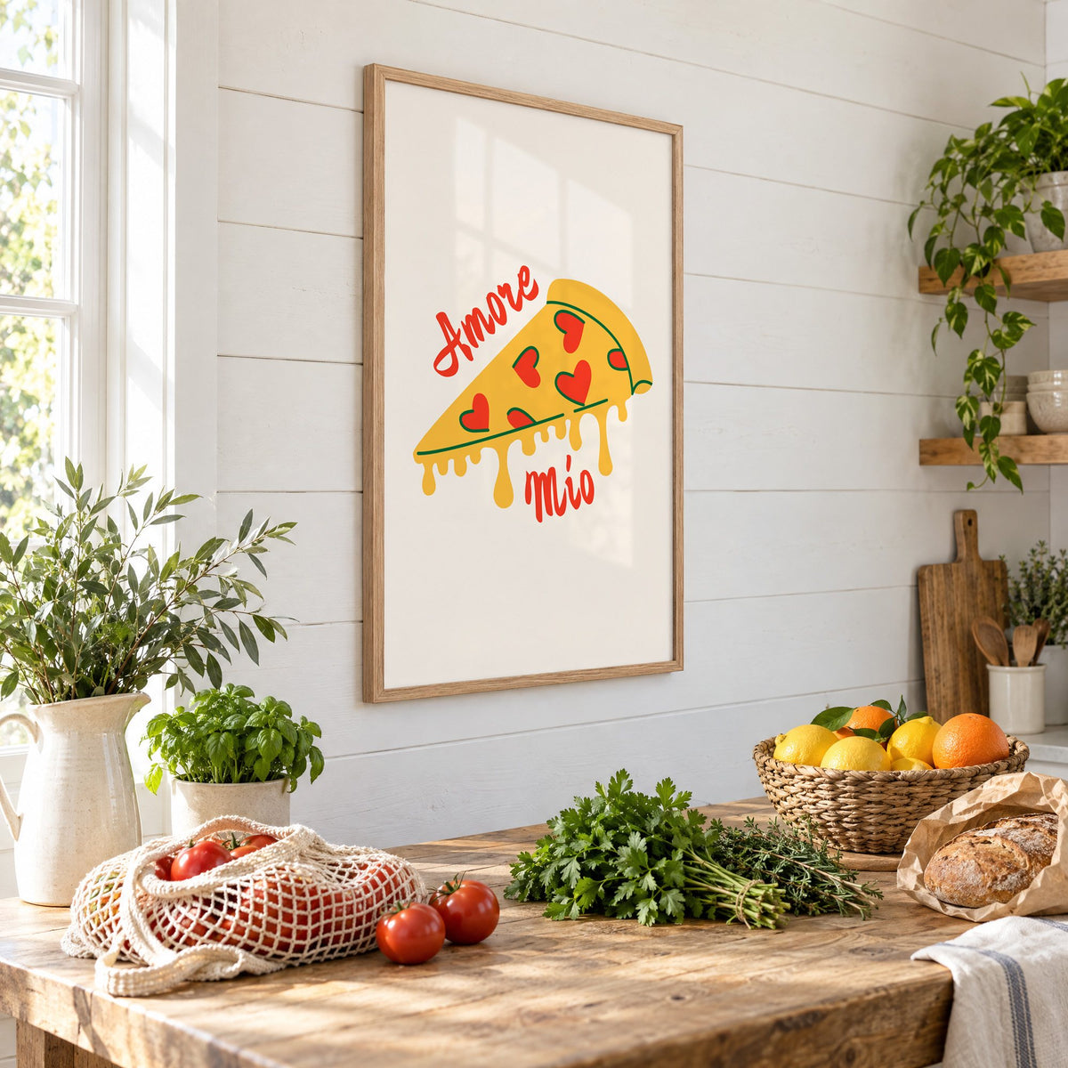 Amore Mio heart pizza slice print in an oak frame on a shiplap wall above a farm table with market tomatoes and citrus, seen at an angle