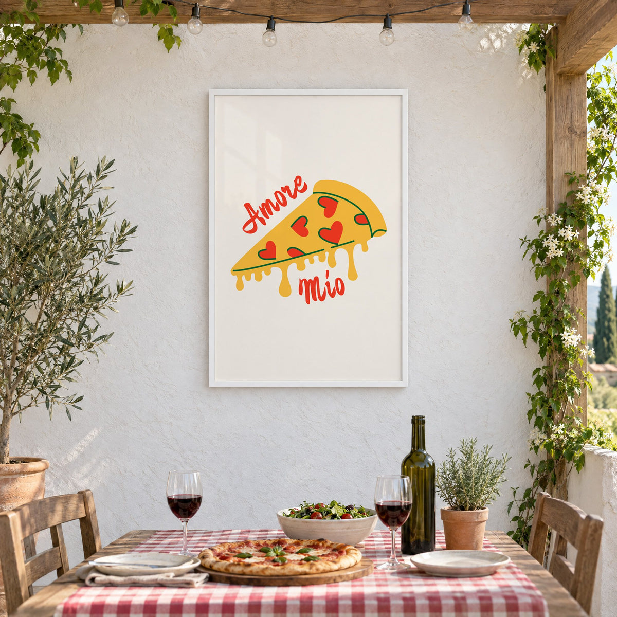 Amore Mio heart pizza slice print in a white frame on a stucco wall above a checked-cloth table with pizza and red wine