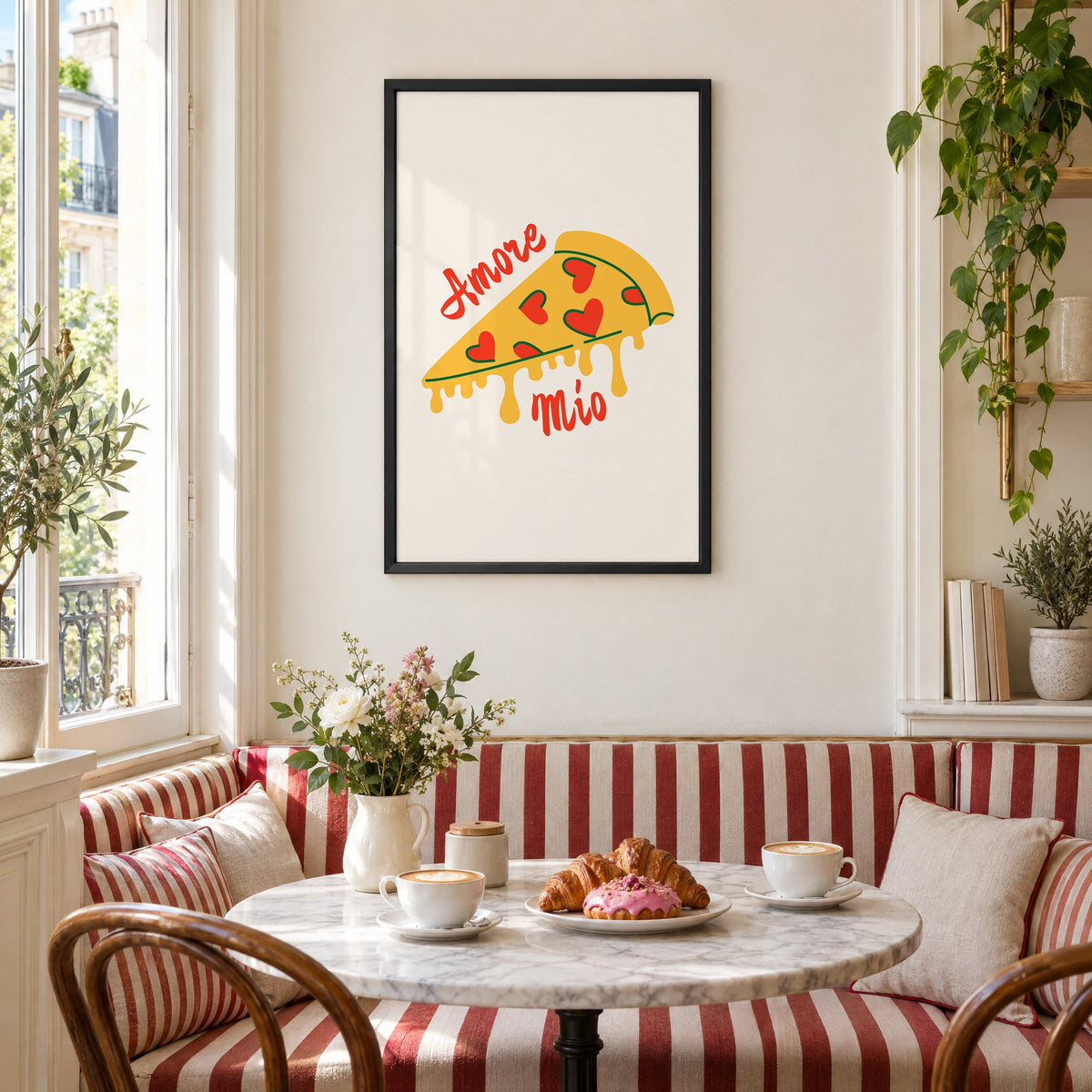Amore Mio heart pizza slice print in a black frame above a striped cafe breakfast nook with cappuccino and pastries