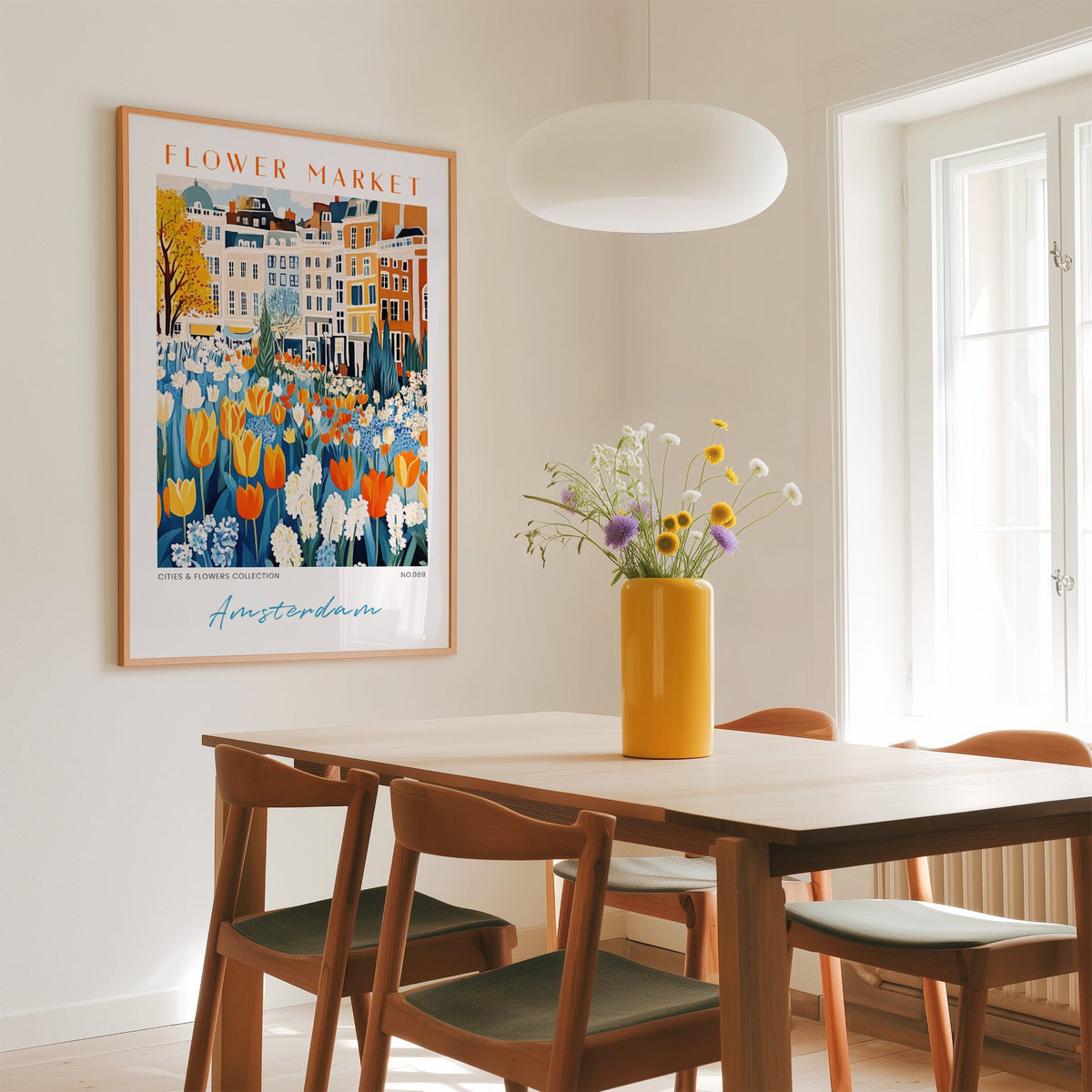 Amsterdam flower market print in an oak frame above a dining table with a yellow vase and white pendant light