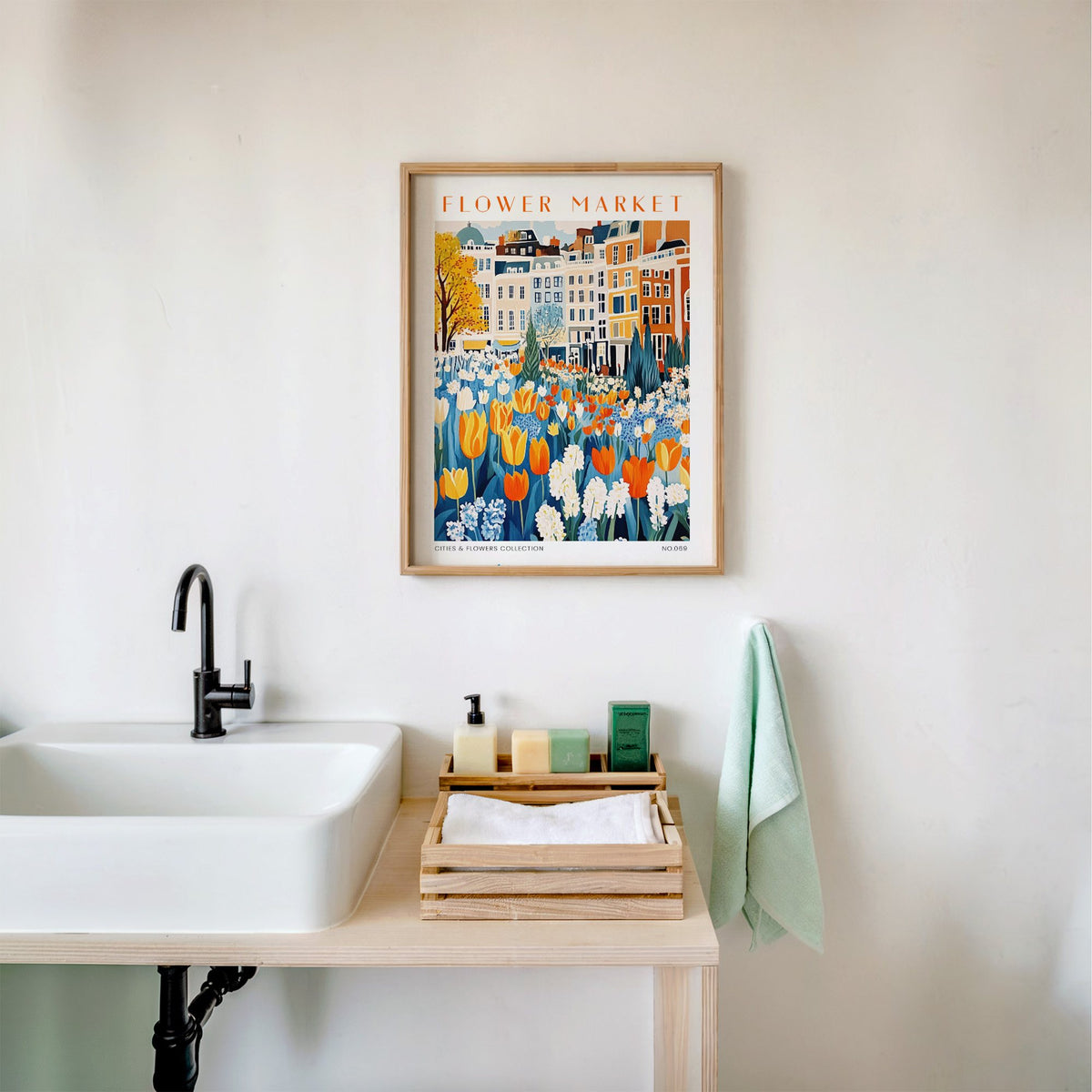 Amsterdam flower market print in an oak frame above a white bathroom sink with folded towels