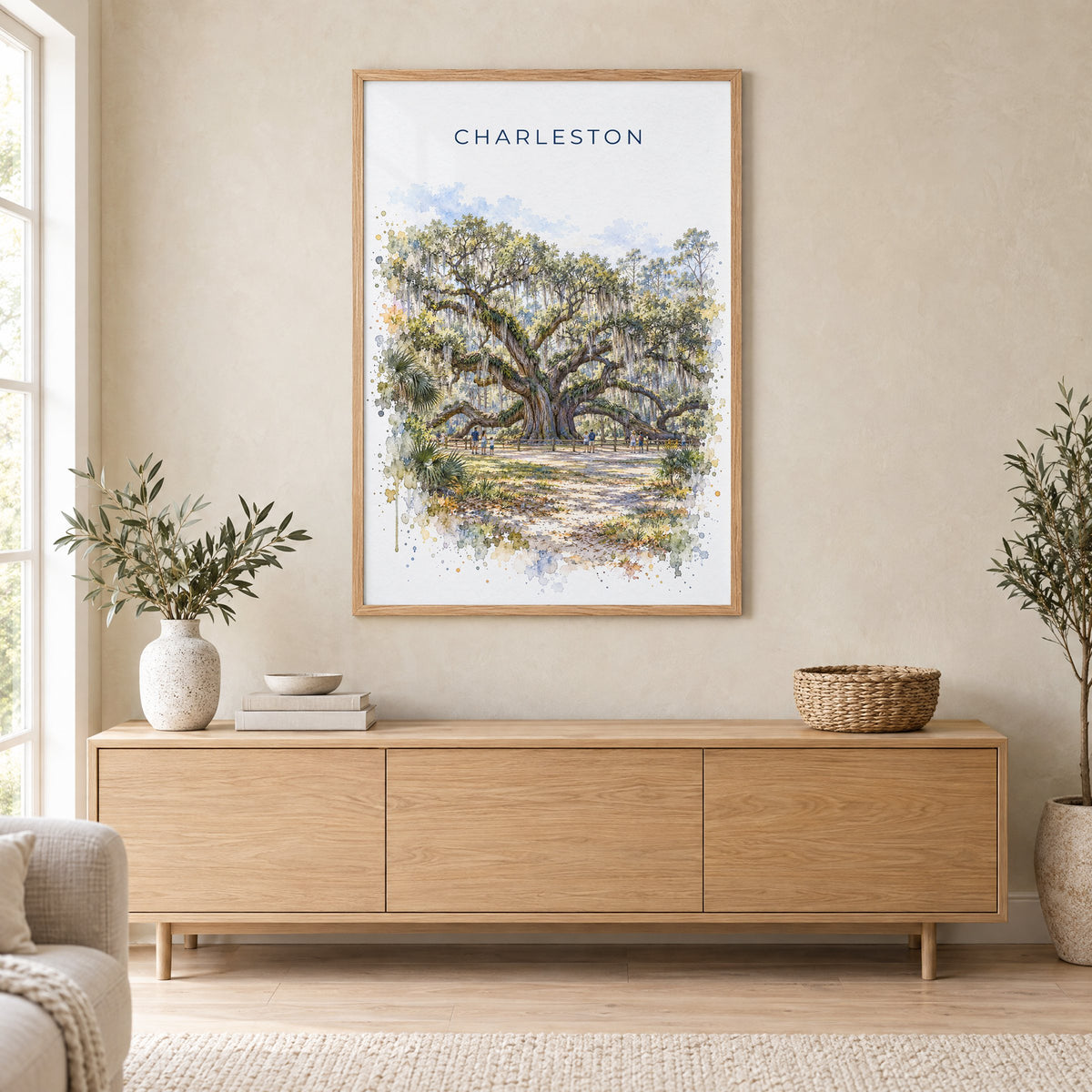 Angel Oak Charleston watercolor print in an oak frame above a light wood sideboard in a Scandinavian living room