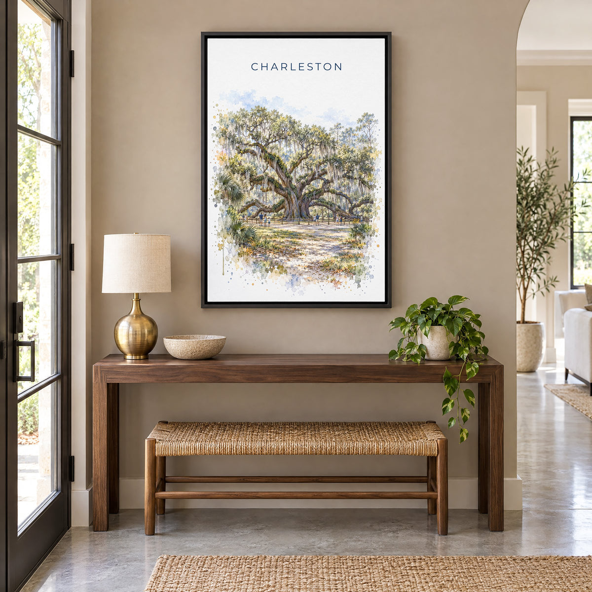 Angel Oak Charleston watercolor print as a black floater canvas above a walnut console and woven bench in an entryway