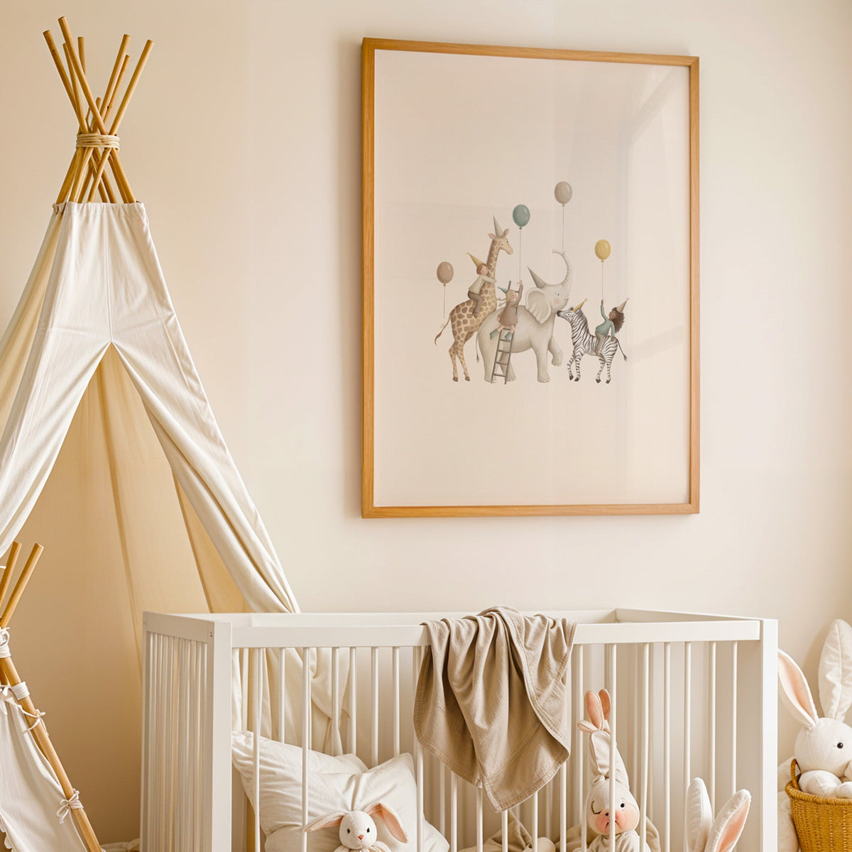 Animal birthday parade with balloons nursery print in an oak frame above a white crib beside a canvas teepee