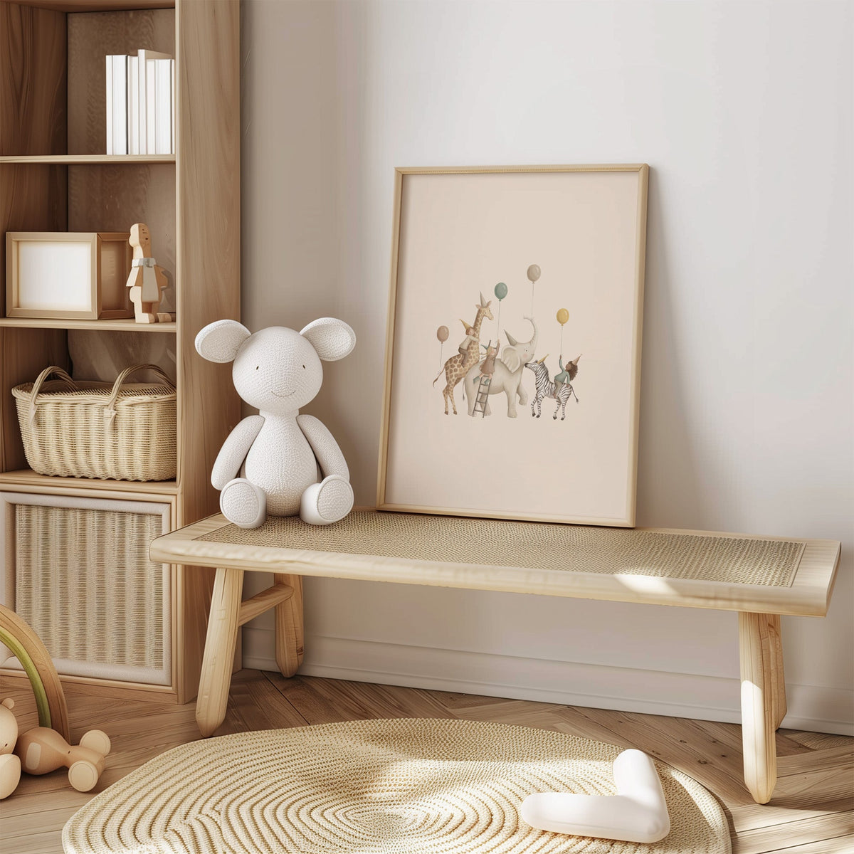 Animal birthday parade with balloons nursery print in an oak frame on a cane bench beside a white knit plush