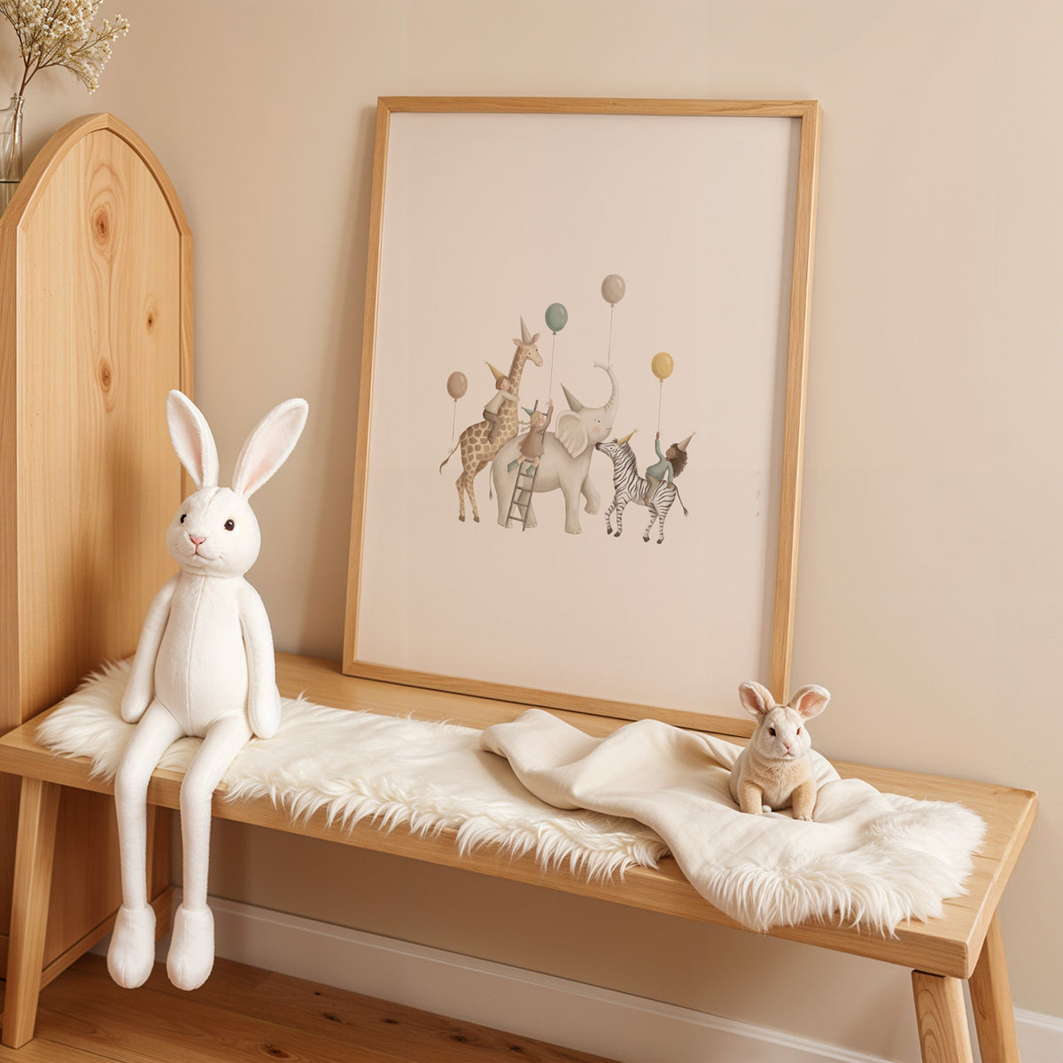 Animal birthday parade with balloons nursery print in an oak frame on a sheepskin bench beside a white plush bunny