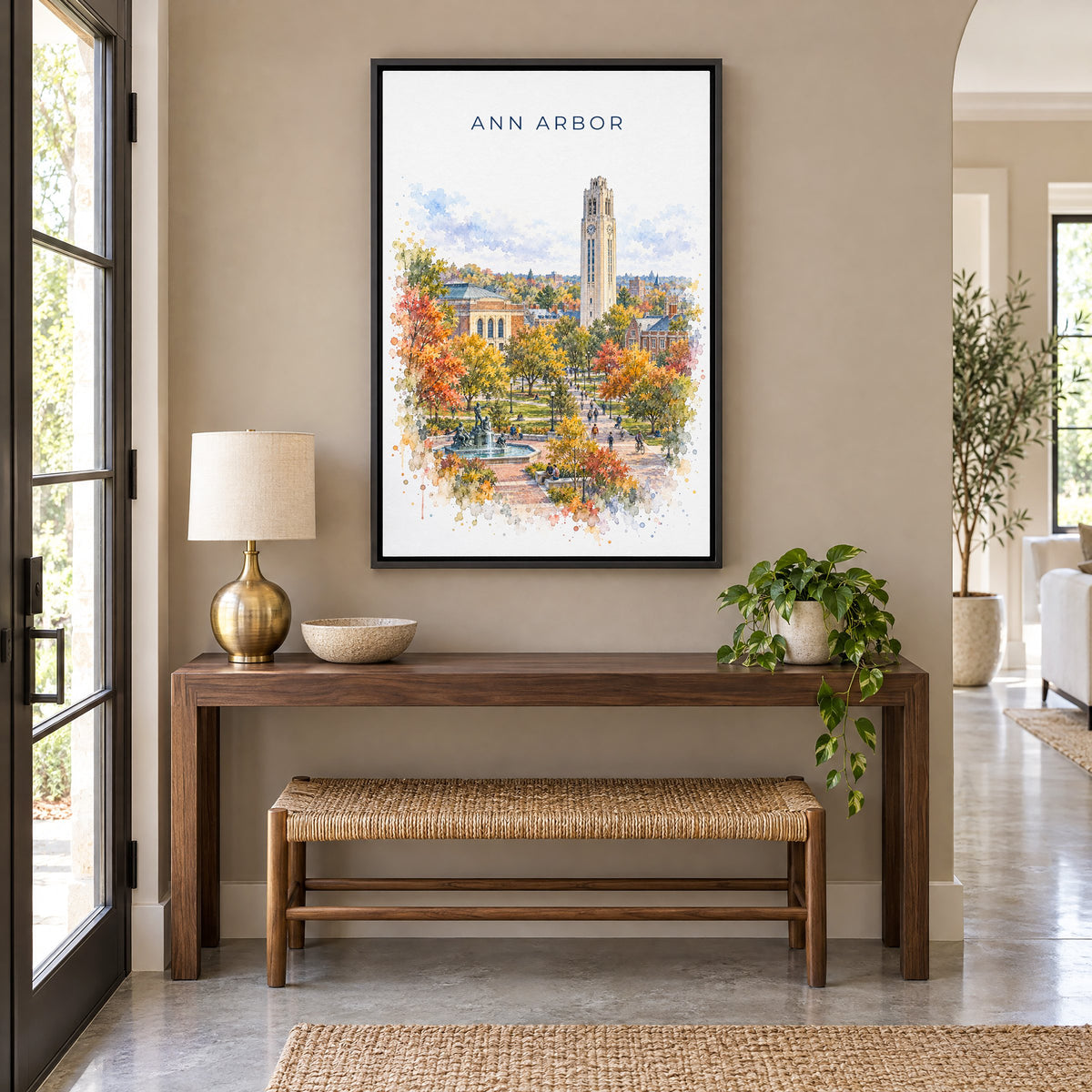 Ann Arbor watercolor print as a black floater canvas above a walnut console and woven bench in an entryway