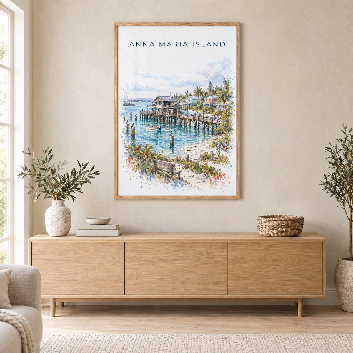 Anna Maria Island watercolor print in an oak frame above a light wood sideboard in a Scandinavian living room