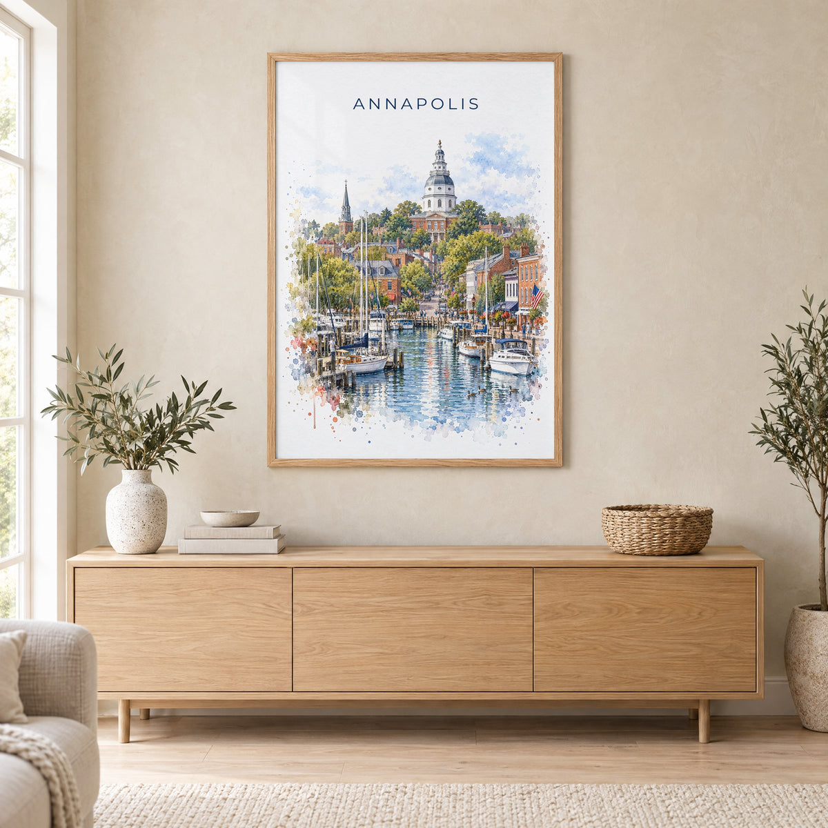 Annapolis watercolor print in an oak frame above a light wood sideboard in a Scandinavian living room