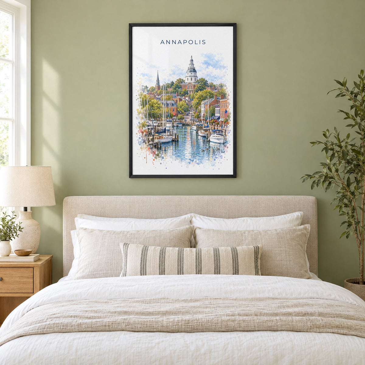 Annapolis watercolor print in a black frame above an upholstered headboard in a sage green bedroom
