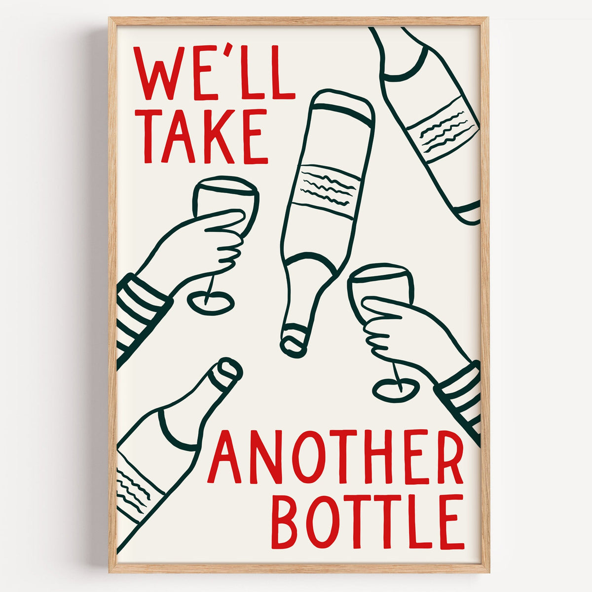 We'll Take Another Bottle wine print in a light oak frame on a plain white wall