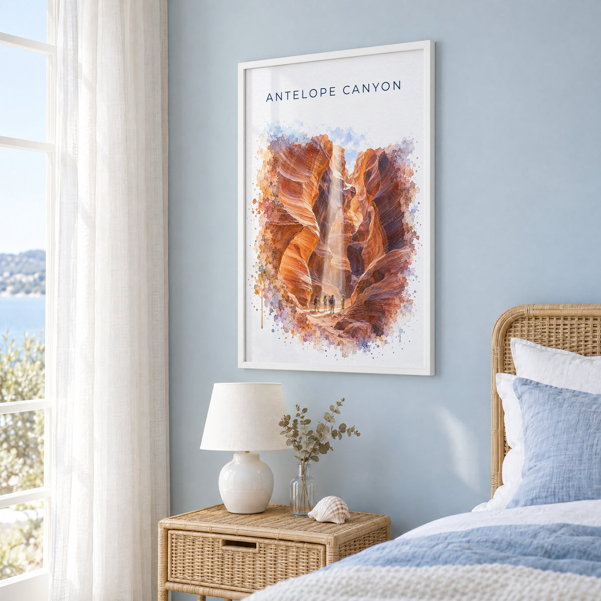 Antelope Canyon watercolor print in a white frame on a pale blue wall beside a rattan bed in a coastal bedroom