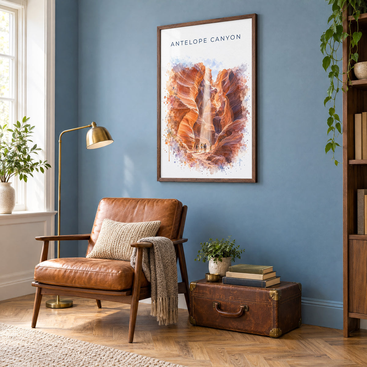 Antelope Canyon watercolor print in a walnut frame on a blue wall above a leather armchair in a reading nook