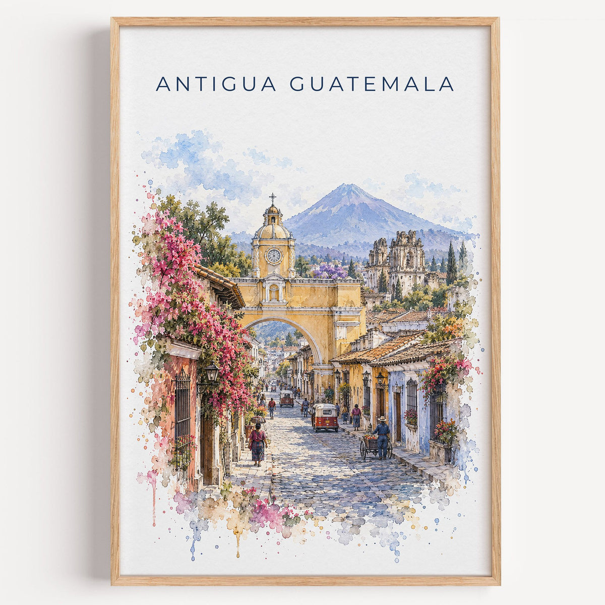 Antigua Guatemala watercolor print in a light oak frame on a plain white wall