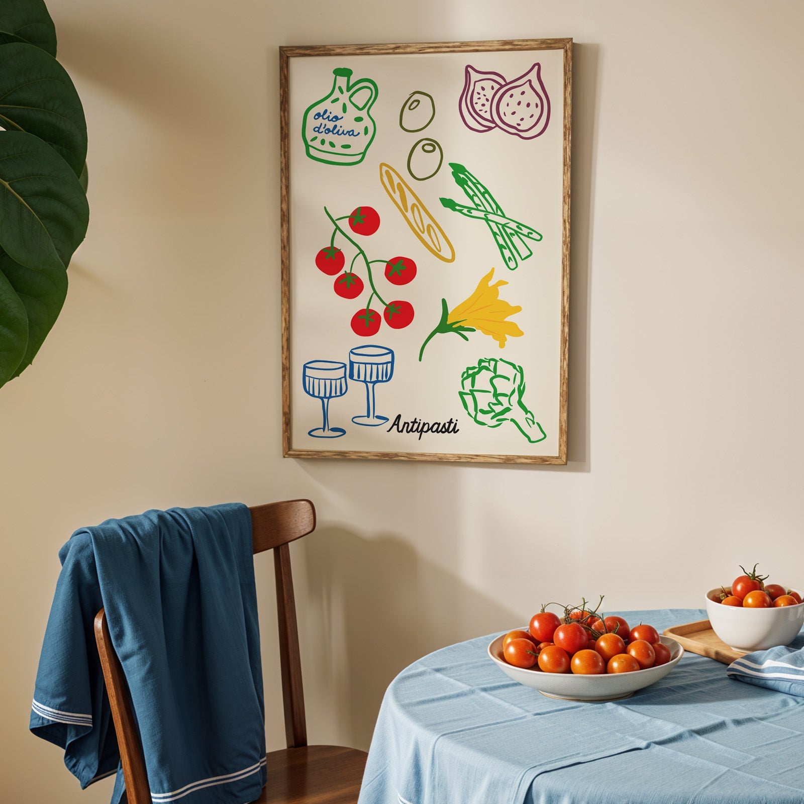 Antipasti line art print in an oak frame above a blue linen table with ripe tomatoes