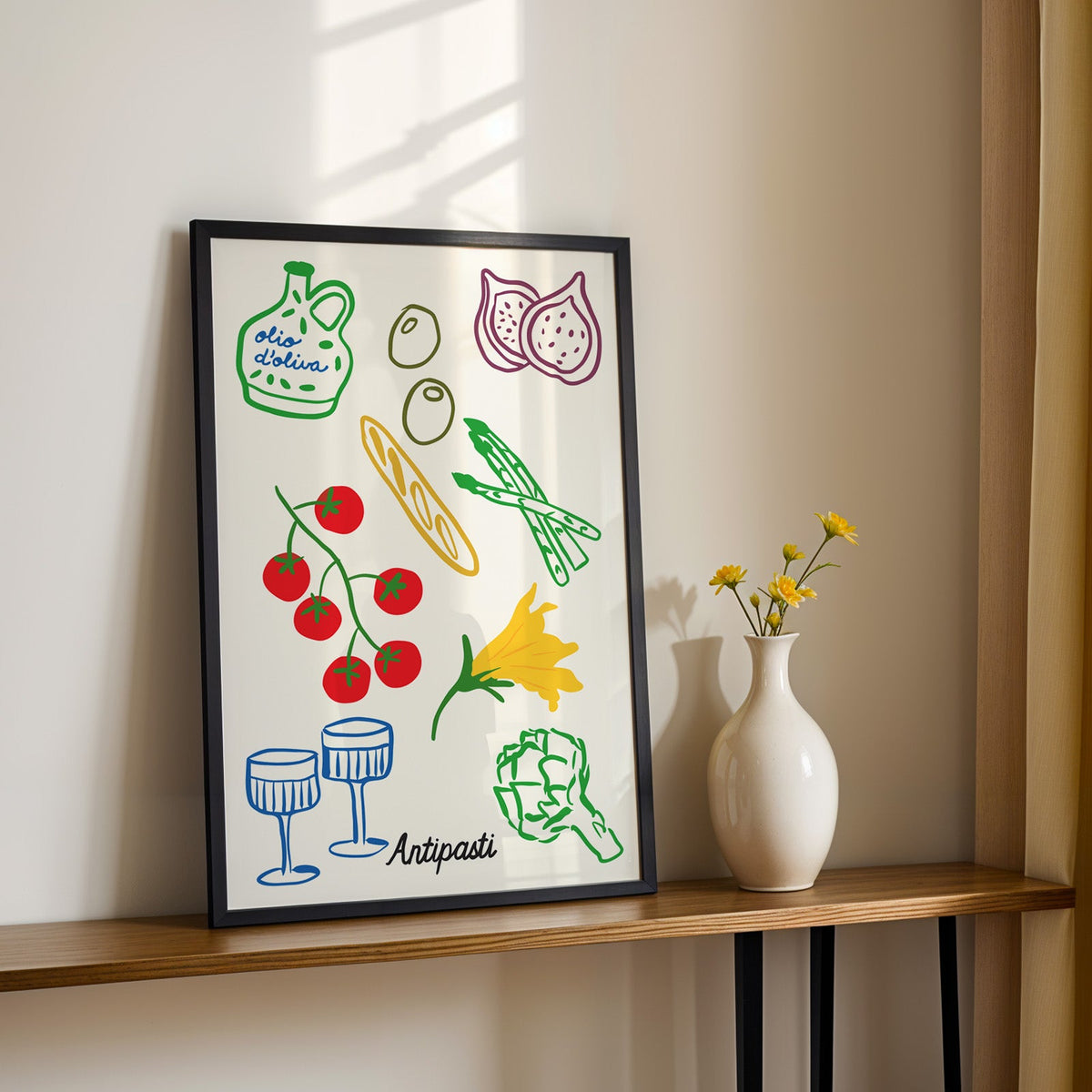 Antipasti line art print in a black frame on a console table with yellow daisies