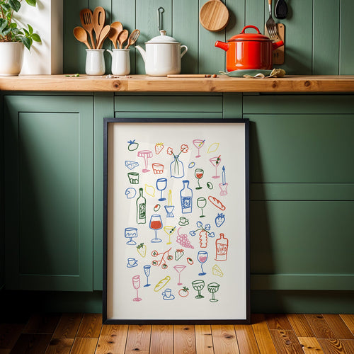 Aperitivo doodle print in a black frame against sage green kitchen cabinets