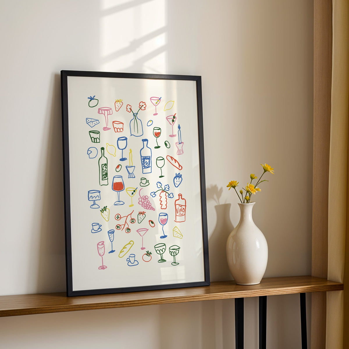 Aperitivo doodle print in a black frame on a console table with yellow daisies