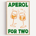 Aperol spritz print in a light oak frame on a plain white wall