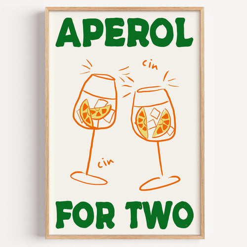 Aperol spritz print in a light oak frame on a plain white wall