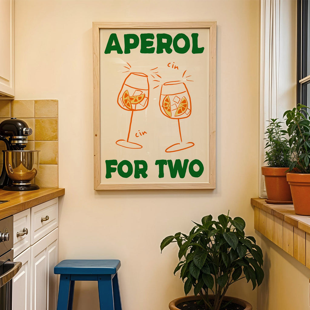 Aperol spritz print in a wood frame on a yellow tiled kitchen wall