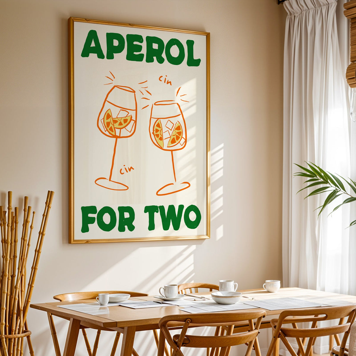 Aperol spritz print in a gold frame above a sunlit breakfast table