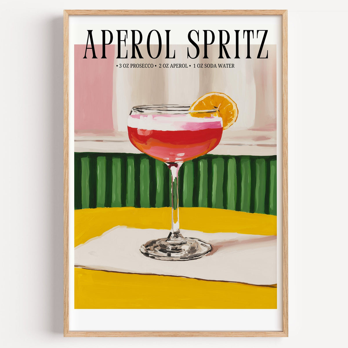 Aperol Spritz recipe print in a light oak frame on a plain white wall