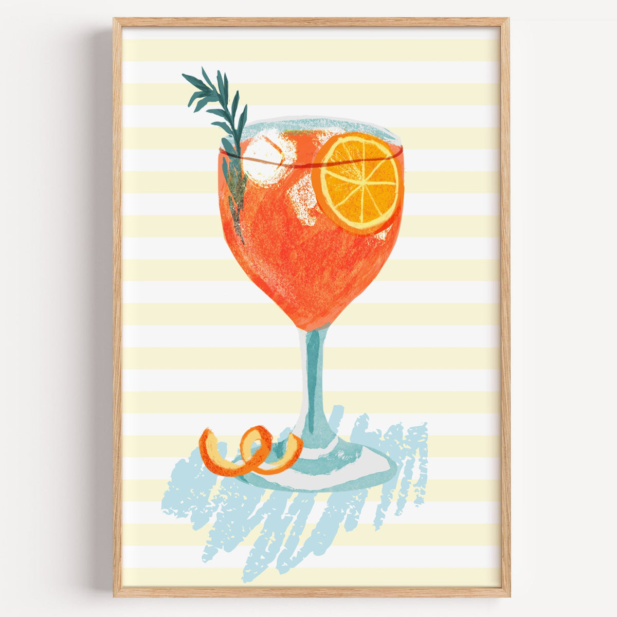 Watercolour aperol spritz print in a light oak frame on a plain white wall