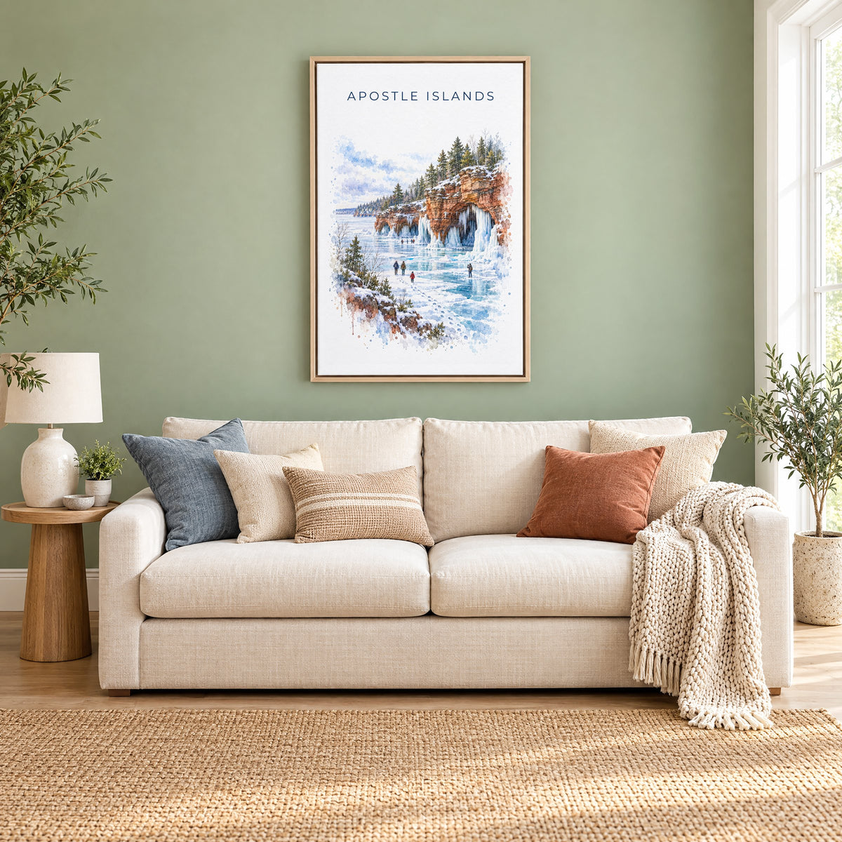 Apostle Islands watercolor print as a natural floater canvas above a cream linen sofa on a sage green wall