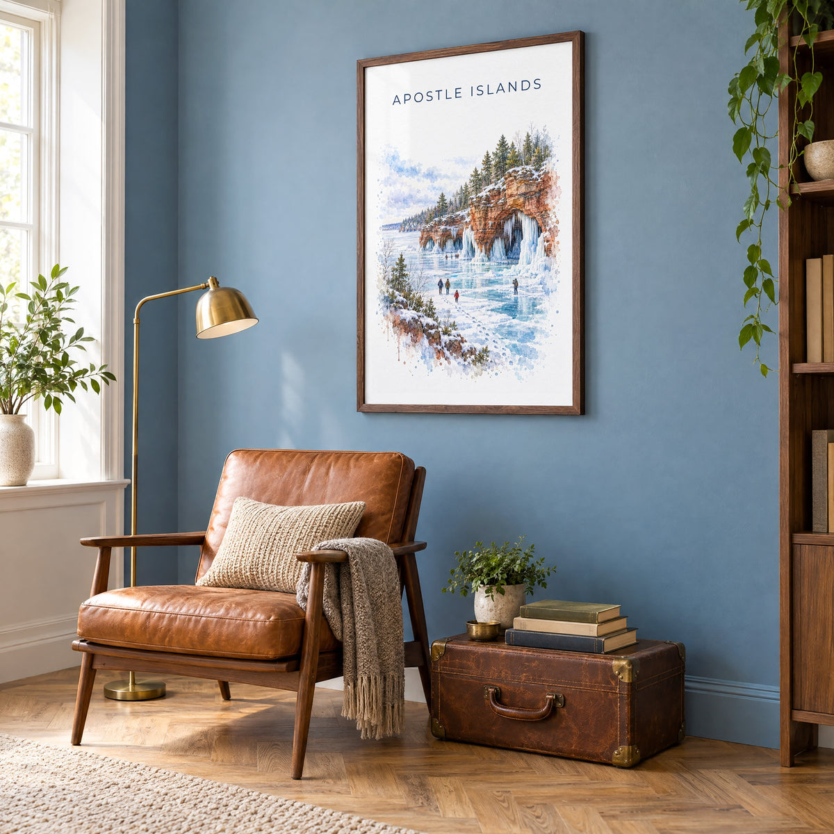 Apostle Islands watercolor print in a walnut frame on a blue wall above a leather armchair in a reading nook