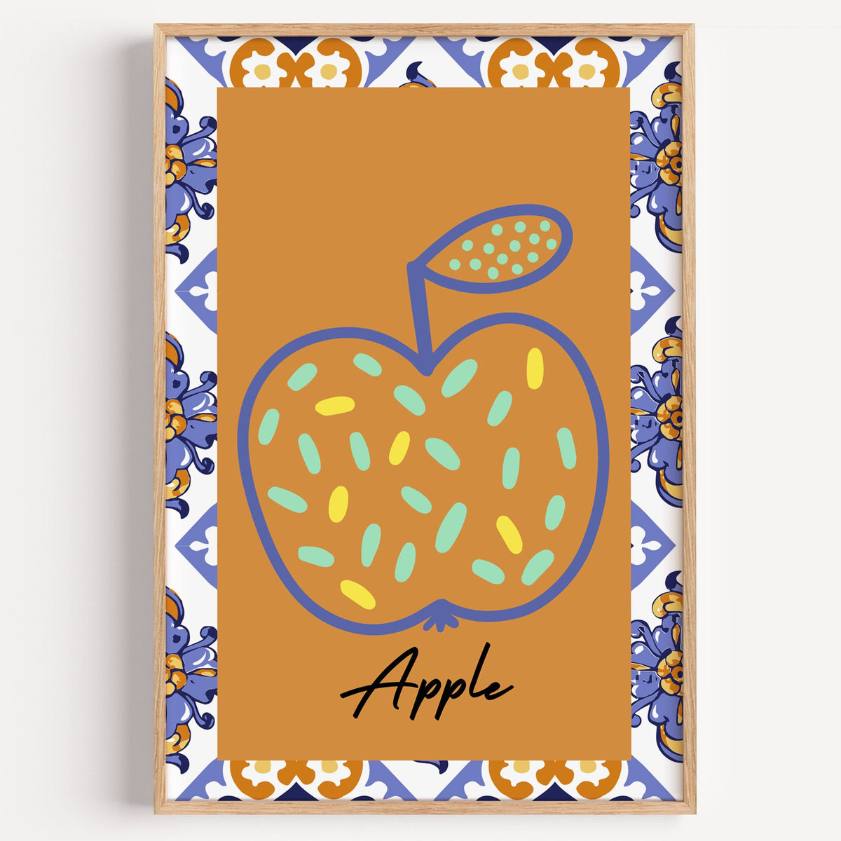 Apple blue outline ochre majolica print in a light oak frame on a plain white wall