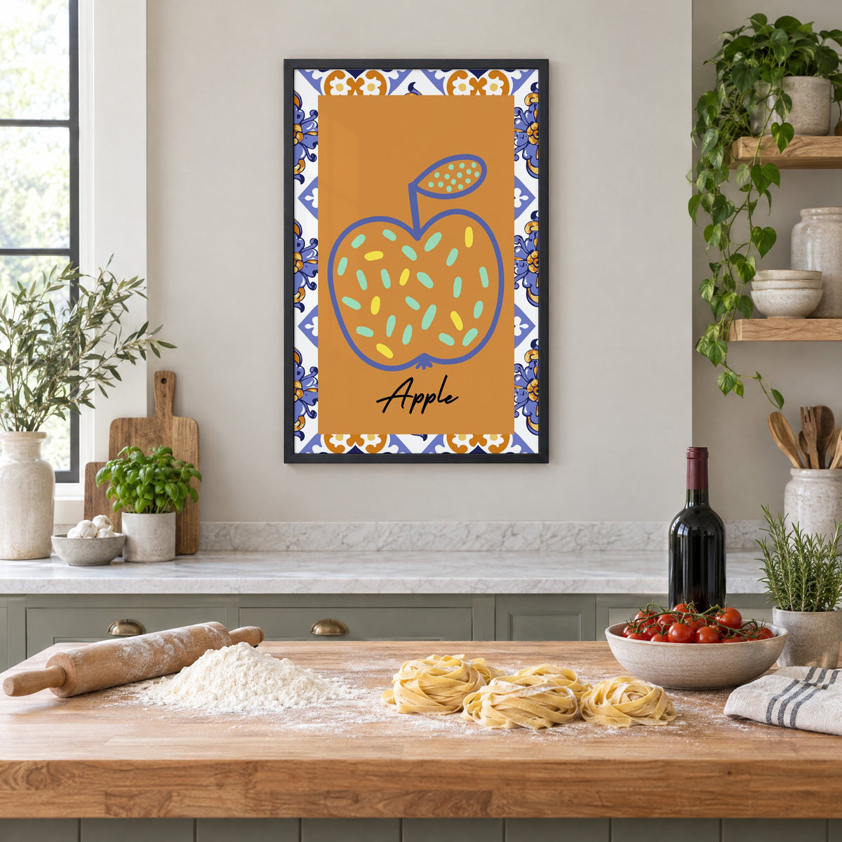 Apple blue outline ochre majolica print in a black frame above a butcher-block island with fresh pasta, flour and cherry tomatoes