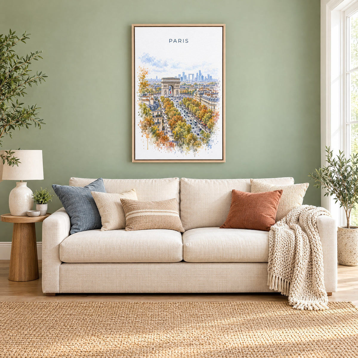 Arc de Triomphe watercolor print as a natural floater canvas above a cream linen sofa on a sage green wall