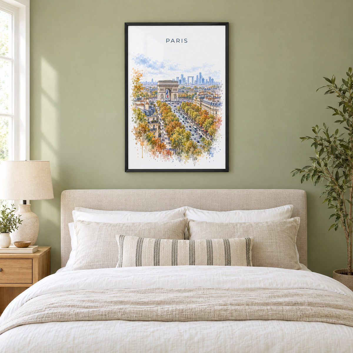 Arc de Triomphe watercolor print in a black frame above an upholstered headboard in a sage green bedroom