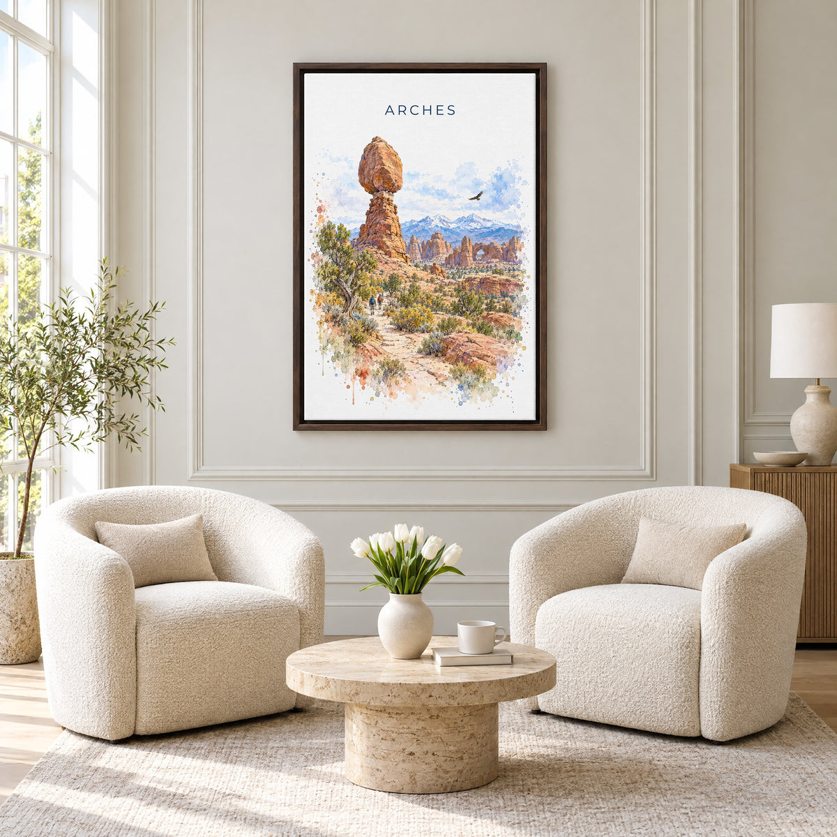 Arches National Park watercolor print as an espresso floater canvas above two boucle armchairs in a hotel lounge