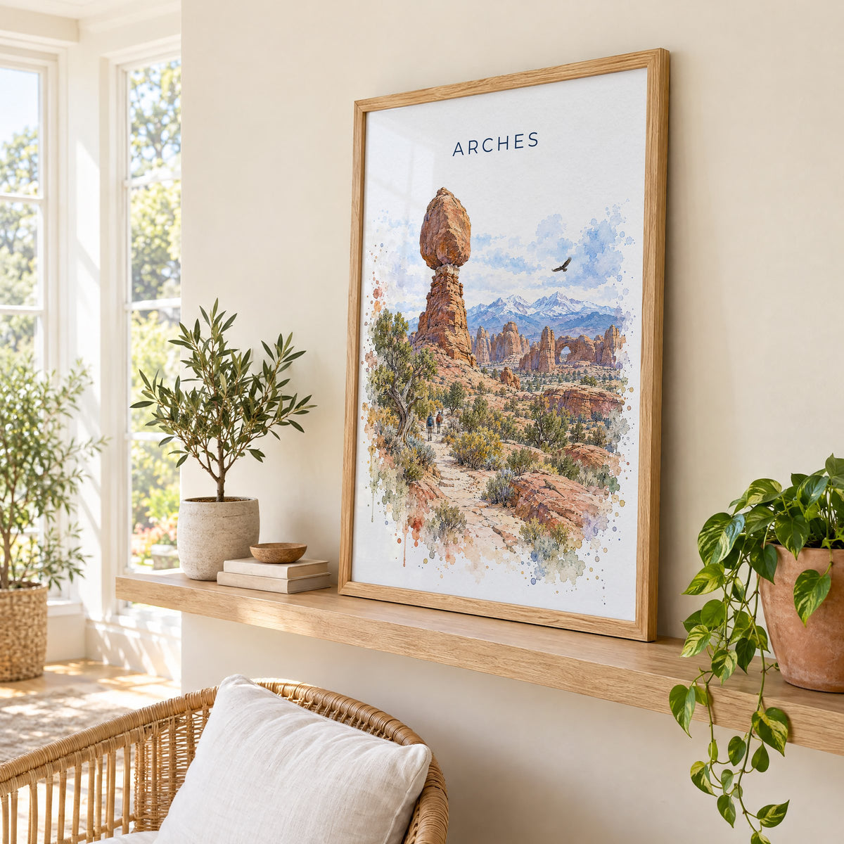 Arches National Park watercolor print in an oak frame on a picture ledge in a sunlit sunroom