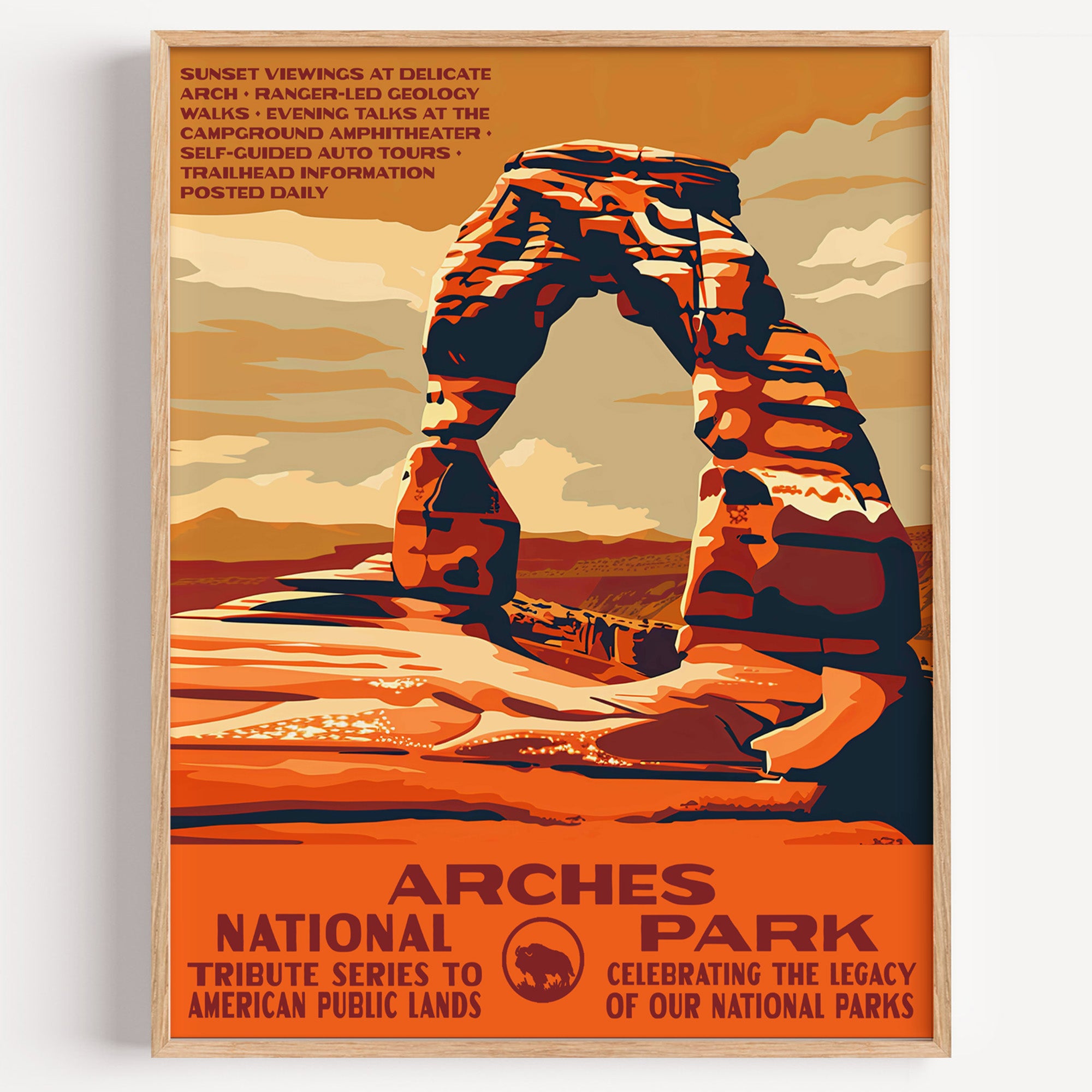 Arches National Park wall art print in a thin wood frame, Delicate Arch standing alone against a burnt-orange sky