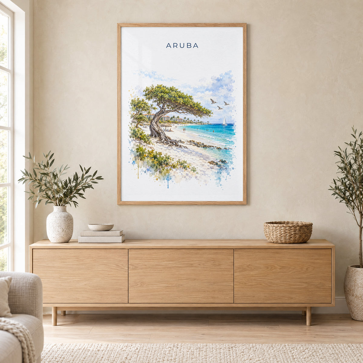 Aruba watercolor print in an oak frame above a light wood sideboard in a Scandinavian living room
