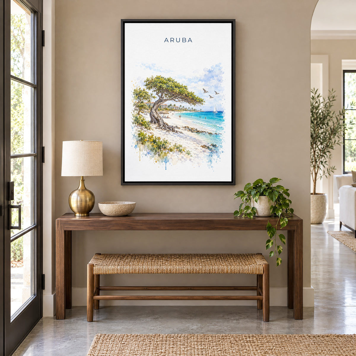 Aruba watercolor print as a black floater canvas above a walnut console and woven bench in an entryway