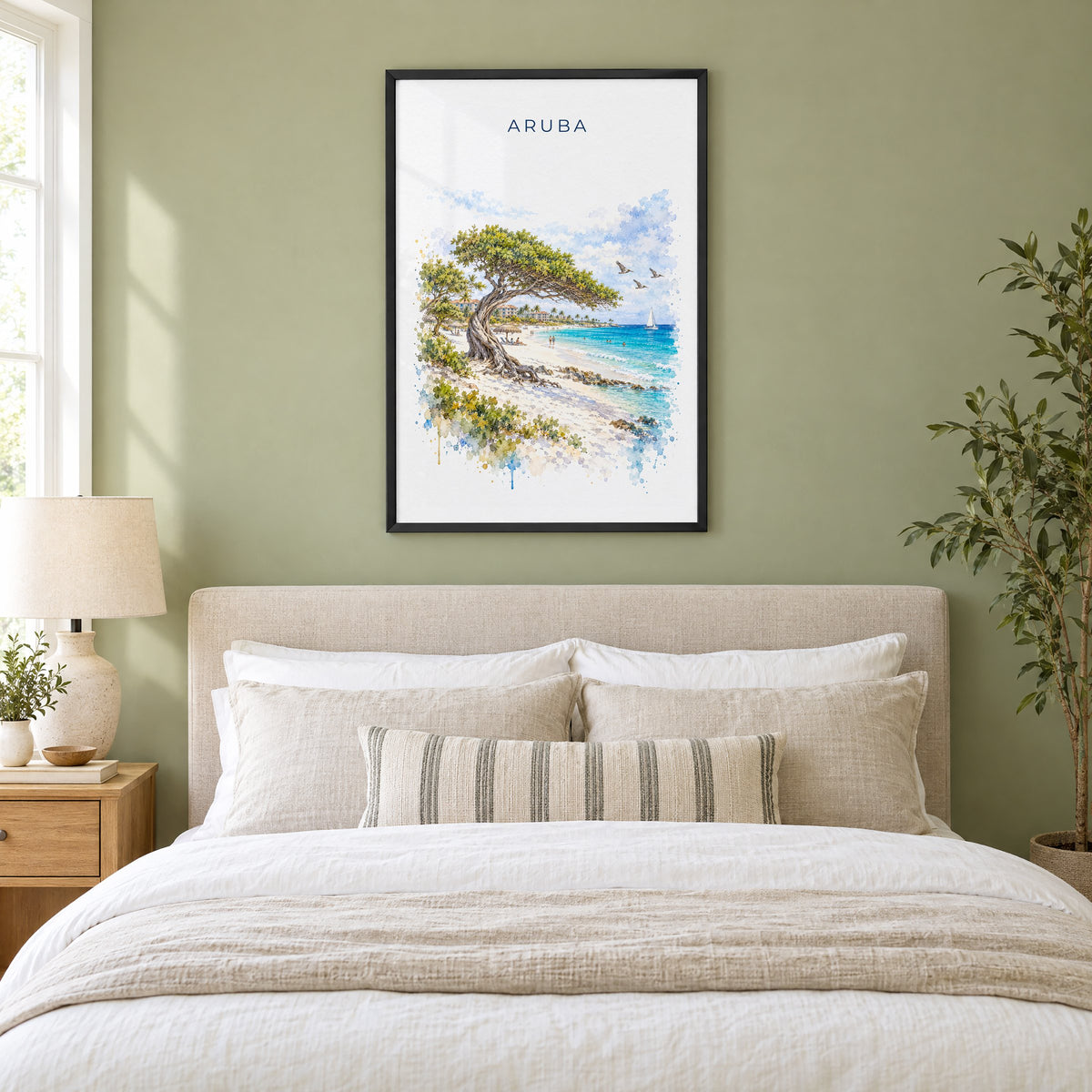 Aruba watercolor print in a black frame above an upholstered headboard in a sage green bedroom