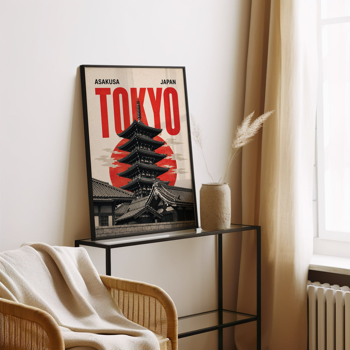Asakusa Tokyo pagoda poster in a black frame leaning on a glass console beside pampas grass