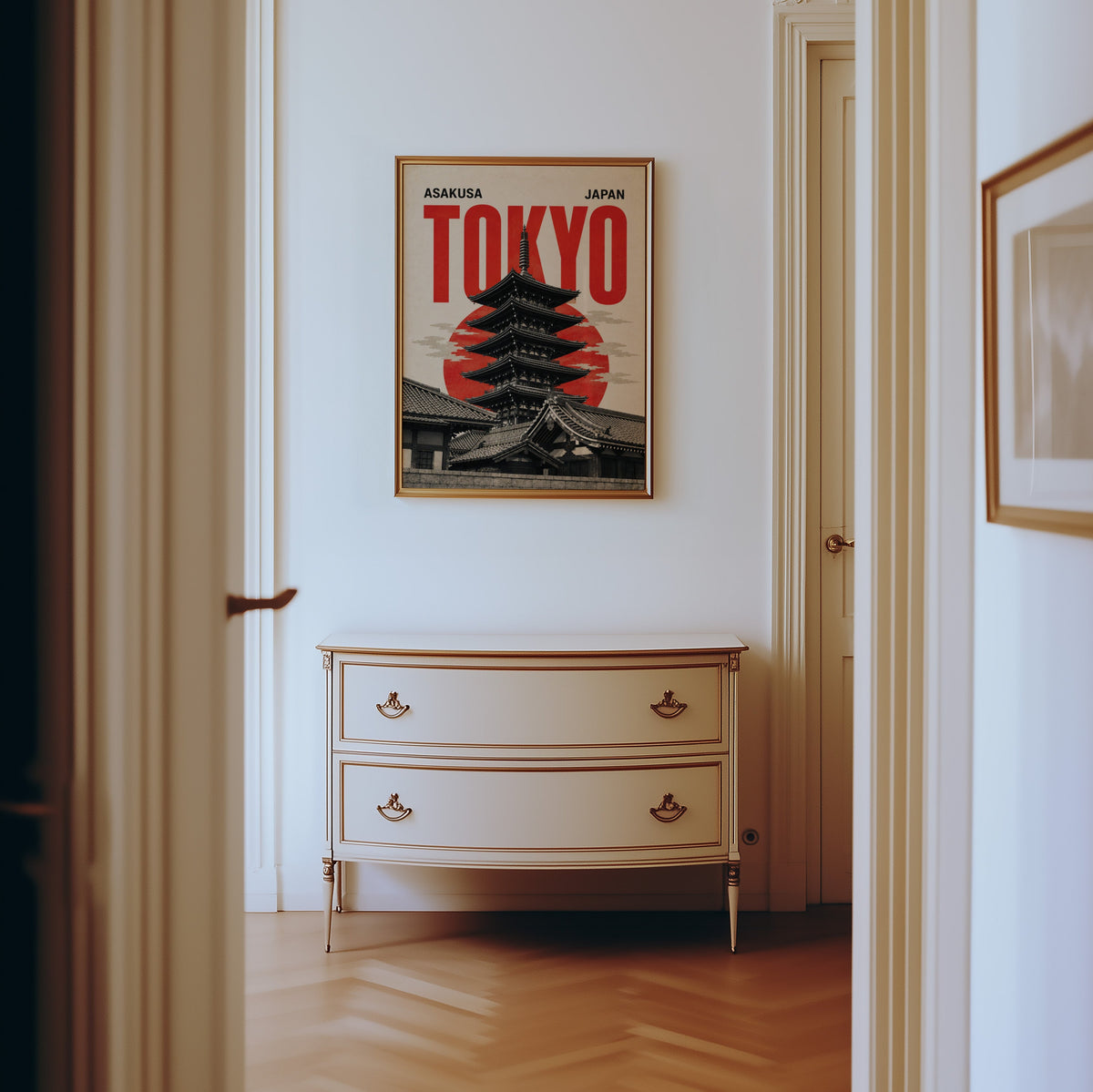 Asakusa Tokyo pagoda poster shown in a gold frame in a hallway above a cream dresser