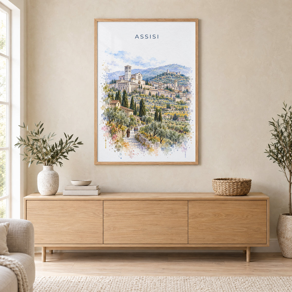Assisi watercolor print in an oak frame above a light wood sideboard in a Scandinavian living room