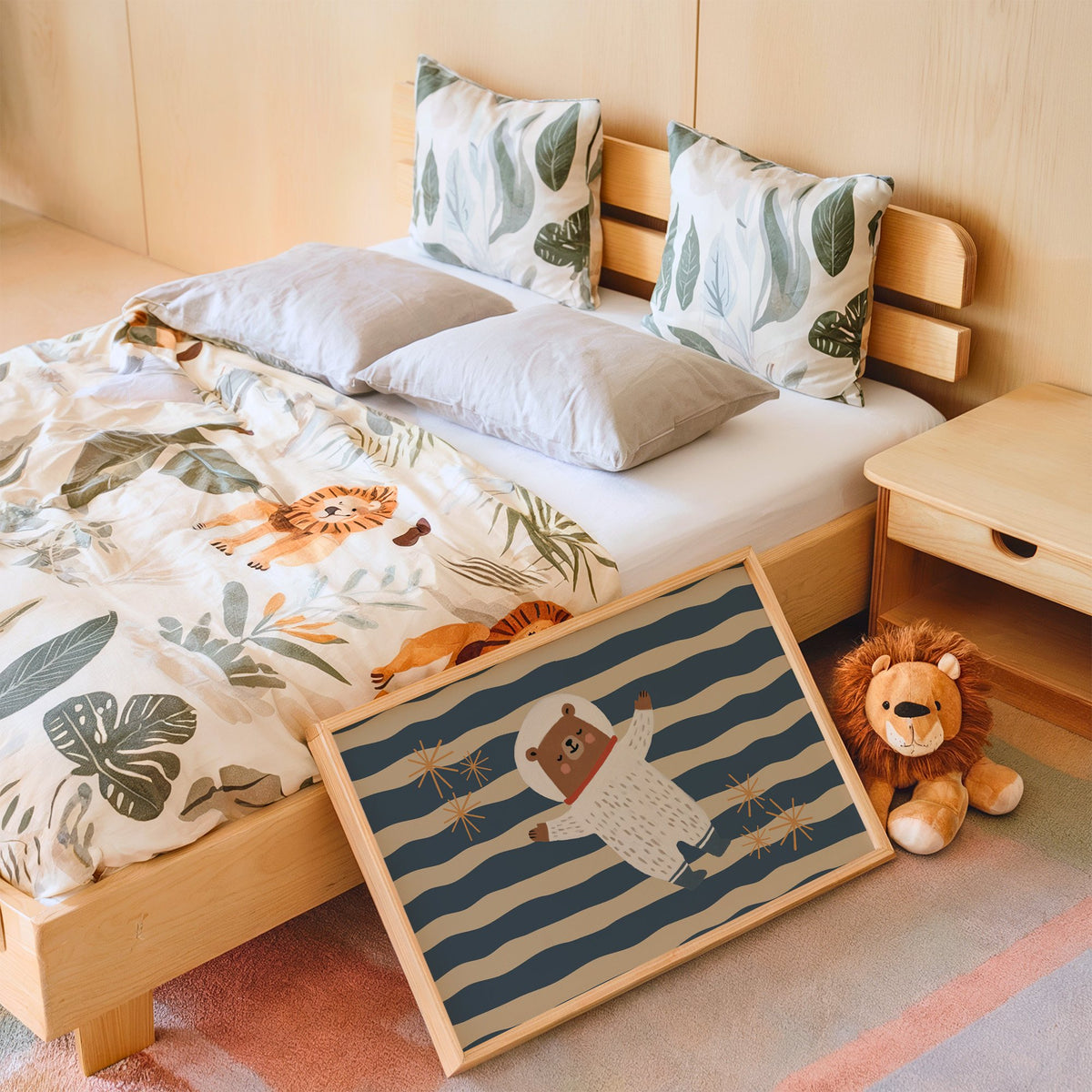 Landscape astronaut bear wavy stripe nursery print in an oak frame leaning on a kids bed by a lion plush