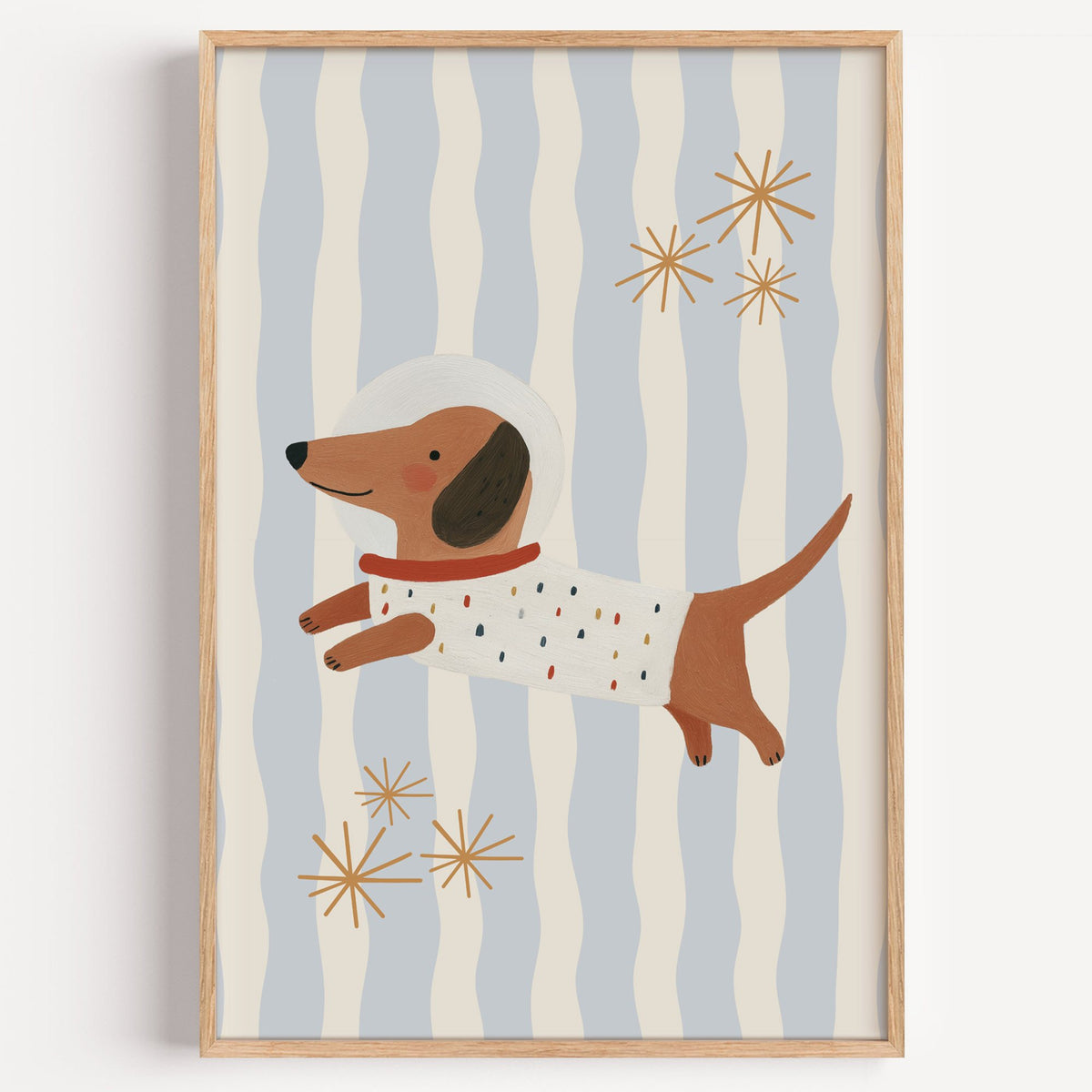 Astronaut dachshund wavy stripe nursery print in a light oak frame on a plain white wall