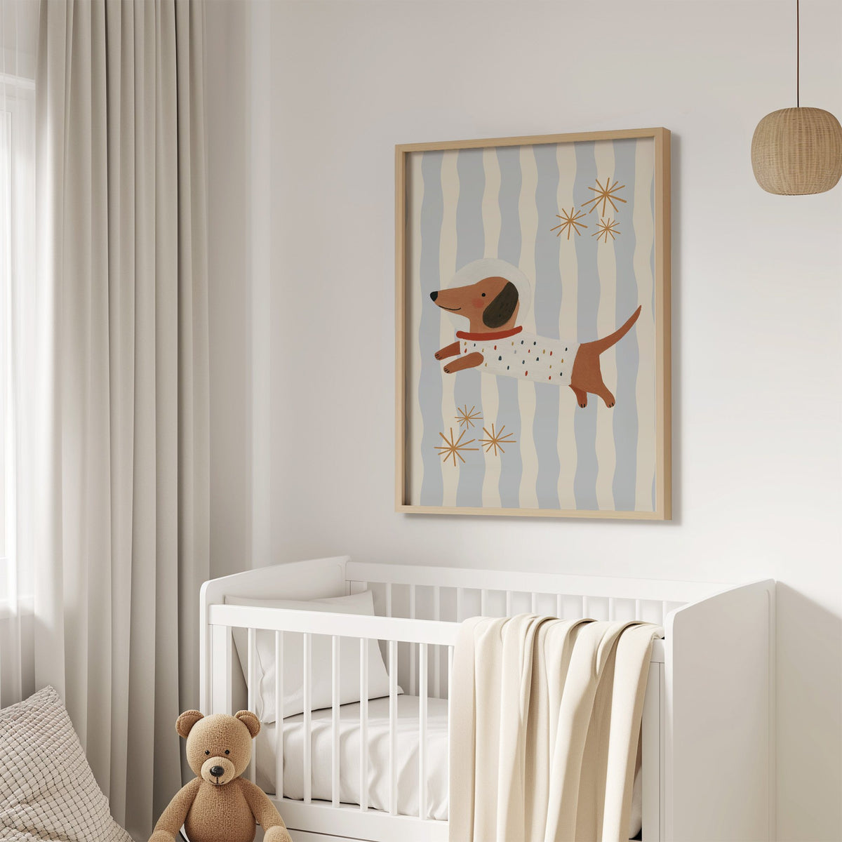 Astronaut dachshund wavy stripe nursery print in an oak frame above a white crib with a teddy bear