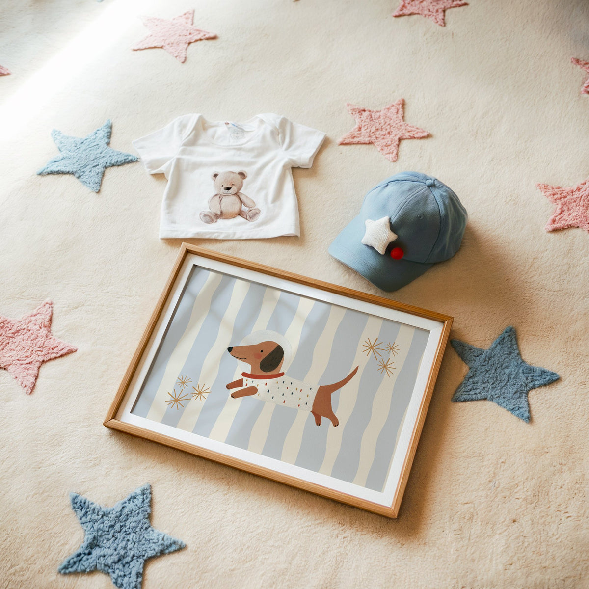 Landscape astronaut dachshund wavy stripe nursery print in a matted oak frame on a star rug with a baby tee