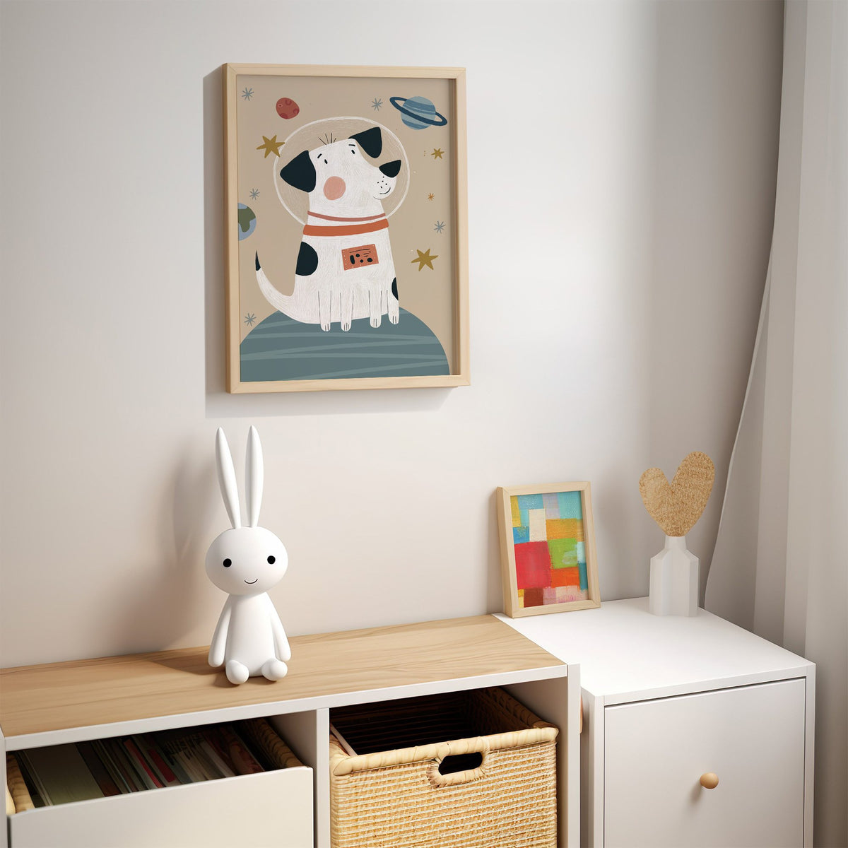 Spotted dog astronaut planet nursery print in an oak frame above a kids cubby shelf with a woven basket and bunny lamp