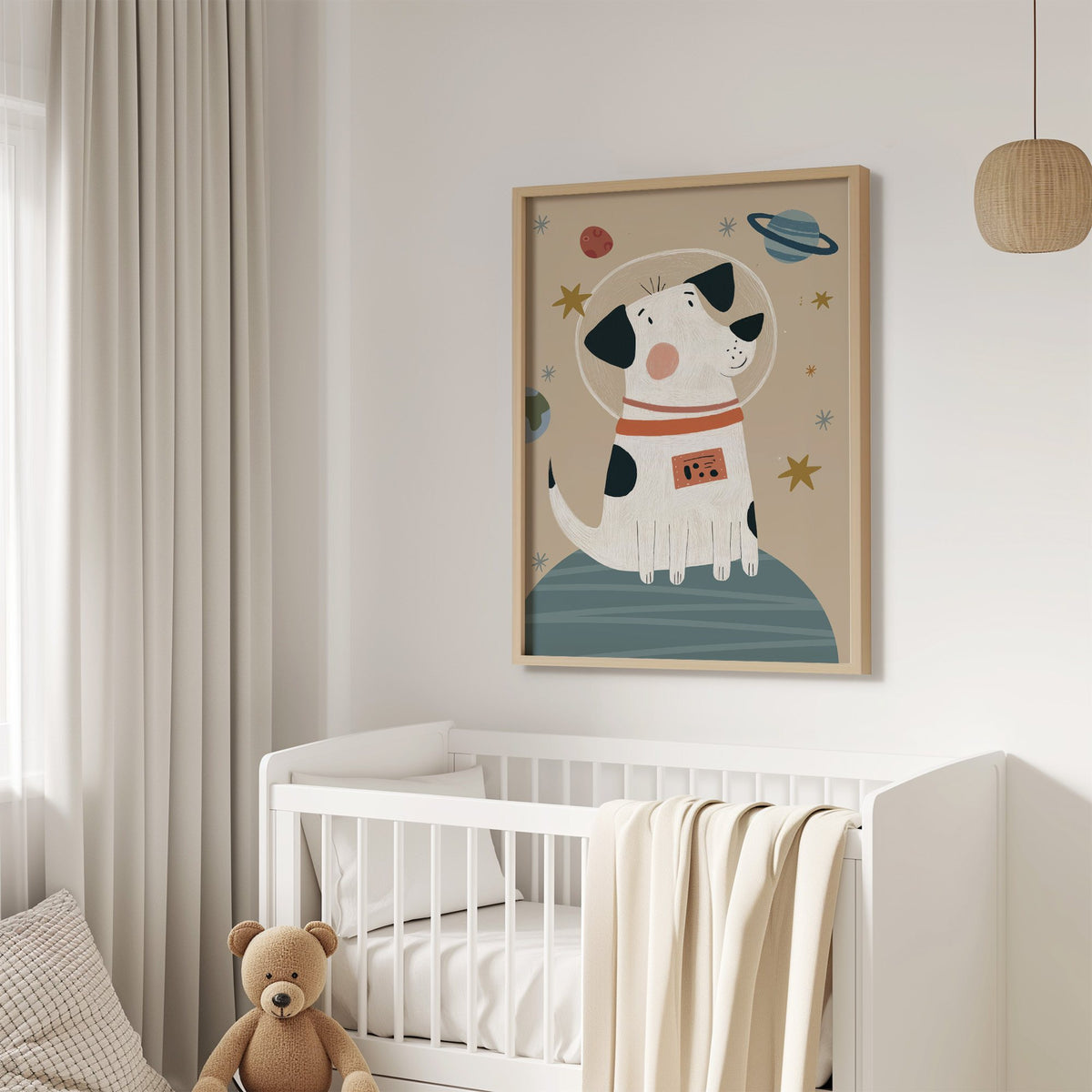 Spotted dog astronaut planet nursery print in an oak frame above a white crib with a teddy bear