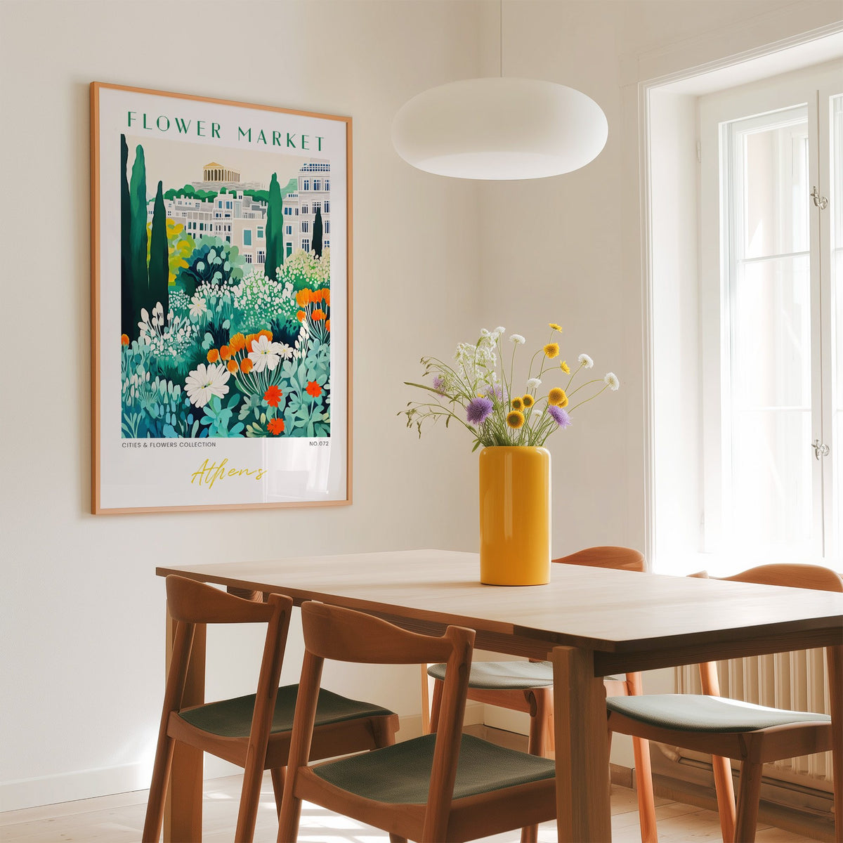 Athens flower market print in an oak frame above a dining table with a yellow vase and white pendant light